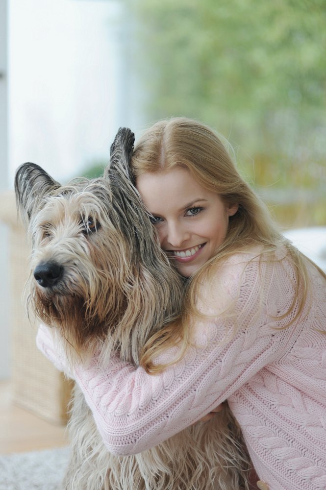smiling woman hugging dog at home 2022 03 04 01 50 00 utc